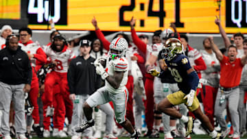 Ohio State Buckeyes wide receiver Jeremiah Smith (4) makes a catch against Notre Dame Fighting Irish cornerback Christian Gray (29) in the fourth quarter during the College Football Playoff National Championship at Mercedes-Benz Stadium in Atlanta on January 20, 2025.