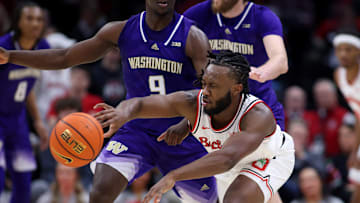 Feb 12, 2025; Columbus, Ohio, USA;  Ohio State Buckeyes guard Bruce Thornton (2) passes the ball as Washington Huskies guard Zoom Diallo (9) and forward Wilhelm Breidenbach (32) defend during the first half at Value City Arena. Mandatory Credit: Joseph Maiorana-Imagn Images