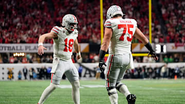 Ohio State Buckeyes quarterback Will Howard (18) celebrates a touchdown with offensive lineman Carson Hinzman (75) against the Notre Dame Fighting Irish in the second quarter during the College Football Playoff National Championship at Mercedes-Benz Stadium in Atlanta on January 20, 2025. Mandatory Credit:  Adam Cairns/USA TODAY NETWORK via Imagn Images