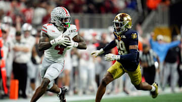 Ohio State Buckeyes wide receiver Jeremiah Smith (4) makes a catch against Notre Dame Fighting Irish cornerback Christian Gray (29) in the fourth quarter during the College Football Playoff National Championship at Mercedes-Benz Stadium in Atlanta on January 20, 2025.