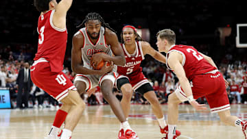 Feb 6, 2024; Columbus, Ohio, USA; Ohio State Buckeyes guard Evan Mahaffey (12) controls the ball as Indiana Hoosiers guard Anthony Leal (3) and guard Gabe Cupps (2) and forward Malik Reneau (5) defend during the second half at Value City Arena. Mandatory Credit: Joseph Maiorana-Imagn Images
