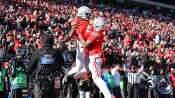 Nov 30, 2024; Columbus, Ohio, USA; Ohio State Buckeyes wide receiver Jeremiah Smith (4) celebrates his touchdown catch with wide receiver Emeka Egbuka (2) during the second quarter against the Michigan Wolverines at Ohio Stadium. Mandatory Credit: Joseph Maiorana-Imagn Images