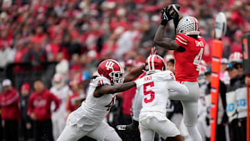 Ohio State Buckeyes wide receiver Jeremiah Smith (4) makes a catch against Indiana Hoosiers defensive lineman Lanell Carr Jr. (41) and defensive back D'Angelo Ponds (5) in the third quarter during the football game in Columbus on Saturday, Nov. 23, 2024.