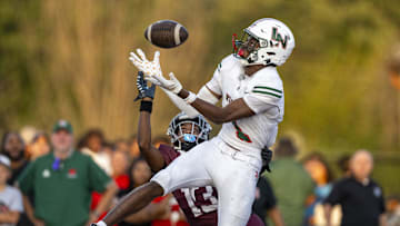 Lawrence North High School sophomore Monshun Sales (1) makes a catch in the end zone to score while being defended by Lawrence Central High School junior DJ Summers (13) during the first half of an IHSAA varsity football game, Friday, Aug. 23, 2024, at Lawrence Central High School.