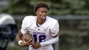 Brownsburg High School sophomore Branden Sharpe (12) warms up on the field before the start of an IHSAA varsity football game against Fishers High School, Friday, Sept. 20, 2024, at Fishers High School.