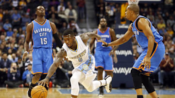 Nov 19, 2014; Denver, CO, USA; Denver Nuggets guard Nate Robinson (5) picks up a loose ball during the first half against the Oklahoma City Thunder at Pepsi Center. Mandatory Credit: Chris Humphreys-Imagn Images