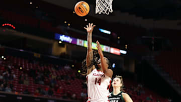 Mar 22, 2025; College Park, Maryland, USA; Alabama Crimson Tide guard Zaay Green (14) takes a shot over Green Bay Phoenix guard Maddy Schreiber (34) during the first half at Xfinity Center. Mandatory Credit: Daniel Kucin Jr.-Imagn Images