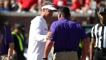 Oct 23, 2021; Oxford, Mississippi, USA; Mississippi Rebels head coach Lane Kiffin and LSU Tigers head coach Ed Orgeron talk prior to their game at Vaught-Hemingway Stadium. Mandatory Credit: Petre Thomas-Imagn Images