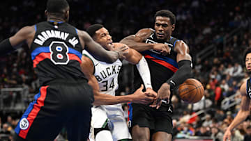 Dec 3, 2024; Detroit, Michigan, USA;  Milwaukee Bucks forward Giannis Antetokounmpo (34) gets fouled by Detroit Pistons center Jalen Duren (0) and forward Tim Hardaway Jr. (8) as he drives to the basket in the first quarter at Little Caesars Arena. Mandatory Credit: Lon Horwedel-Imagn Images