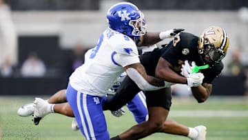 Vanderbilt running back AJ Newberry (23) is stopped by Kentucky linebacker Landyn Watson (9) during the second quarter at FirstBank Stadium in Nashville, Tenn., Saturday, Nov. 22, 2025.