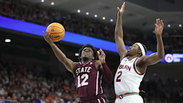 Jan 14, 2025; Auburn, Alabama, USA;  Mississippi State Bulldogs guard Josh Hubbard (12) takes a shot against Auburn Tigers guard Denver Jones (2) during the first half at Neville Arena. Mandatory Credit: John Reed-Imagn Images