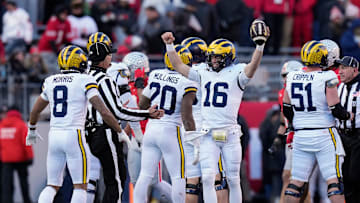Michigan Wolverines quarterback Davis Warren (16) celebrates a 13-10 win over Ohio State Buckeyes at the end of the NCAA football game at Ohio Stadium in Columbus on Saturday, Nov. 30, 2024.