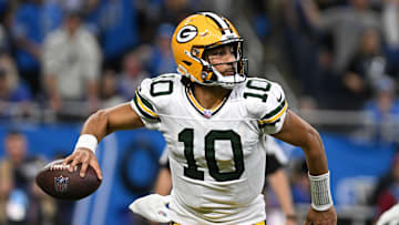 Dec 5, 2024; Detroit, Michigan, USA;  Green Bay Packers quarterback Jordan Love (10) looks for an open receiver as he scrambles out of the pocket against the Detroit Lions in the third quarter at Ford Field. Mandatory Credit: Lon Horwedel-Imagn Images