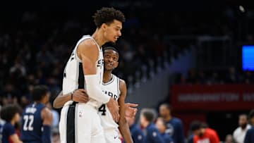 Feb 10, 2025; Washington, District of Columbia, USA; San Antonio Spurs center Victor Wembanyama (1) and guard De'Aaron Fox (4) react during the second quarter against the Washington Wizards at Capital One Arena. Mandatory Credit: Reggie Hildred-Imagn Images