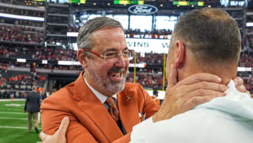 University of Texas at Austin athletic director Chris Del Conte celebrates with head coach Steve