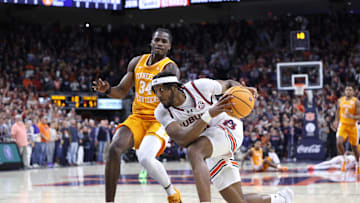 Jan 25, 2025; Auburn, Alabama, USA;  Auburn Tigers forward Chaney Johnson (31) drives against Tennessee Volunteers forward Felix Okpara (34) during the second half at Neville Arena.  Auburn came from behind in the last minute to win the game. Mandatory Credit: John Reed-Imagn Images
