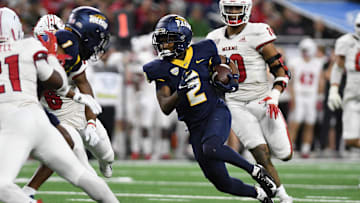 Dec 2, 2023; Detroit, MI, USA;  Toledo Rockets wide receiver Junior Vandeross III (2) runs the ball upfield after catching a pass against the Miami (OH) Redhawks in the second quarter at Ford Field. Mandatory Credit: Lon Horwedel-Imagn Images