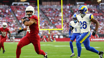 Dec 7, 2025; Glendale, Arizona, USA; Arizona Cardinals wide receiver Michael Wilson (14) runs for a touchdown after a catch against Los Angeles Rams safety Kamren Kinchens (26) during the first half at State Farm Stadium. Mandatory Credit: Mark J. Rebilas-Imagn Images