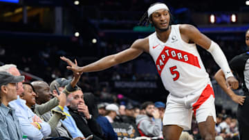 Mar 24, 2025; Washington, District of Columbia, USA; Toronto Raptors guard Immanuel Quickley (5) celebrates with fan during the third quarter against the Washington Wizards at Capital One Arena. Mandatory Credit: Reggie Hildred-Imagn Images