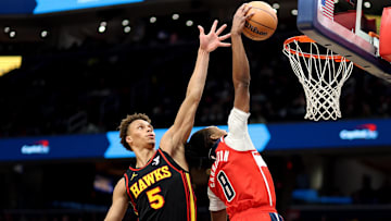 Feb 8, 2025; Washington, District of Columbia, USA; Washington Wizards guard Bub Carrington (8) dunks against Atlanta Hawks guard Dyson Daniels (5) during the second half at Capital One Arena. Mandatory Credit: Daniel Kucin Jr.-Imagn Images