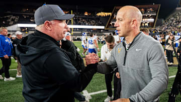 Kentucky coach Mark Stoops greets Vanderbilt coach Clark Lea after Vanderbilt won at FirstBank Stadium in Nashville, Tennessee.