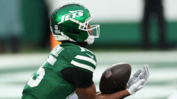 Nov 30, 2025; East Rutherford, New Jersey, USA;New York Jets wide receiver Adonai Mitchell (15) makes a touchdown catch against the Atlanta Falcons during the second half at MetLife Stadium. 