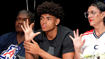 Basketball player Koa Peat sits with his father Todd, left, and mother, Jana, during National Signing Day at Perry High School in Gilbert, Arizona on April 16, 2025.