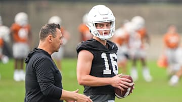 Texas head coach Steve Sarkisian talks to quarterback Arch Manning (16)