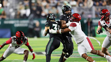 Nov 8, 2025; Honolulu, Hawaii, USA; San Diego State Aztecs defensive lineman Trey White (2) reaches for Hawaii Rainbow Warriors running back Landon Sims (30) in the first quarter at Clarence T.C. Ching Athletics Complex. 