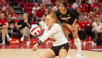 Nebraska defensive specialist Oliva Mauch (front) digs a ball against The Citadel while libero Lexi Rodriguez (back) eyes the ball.