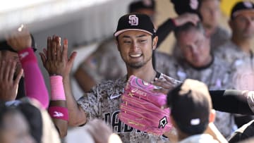 May 12, 2024; San Diego, California, USA; San Diego Padres starting pitcher Yu Darvish (11) is greeted in the dugout after pitching the seventh inning against the Los Angeles Dodgers at Petco Park. 