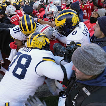 Michigan Wolverines defensive lineman Kenneth Grant (78) goes after Ohio State Buckeyes safety Jaylen McClain after the game during a fight at the middle of the field after the NCAA football game at Ohio Stadium in Columbus on Saturday, Nov. 30, 2024.