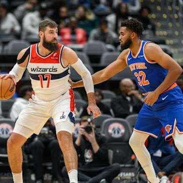 Oct 18, 2024; Washington, District of Columbia, USA; Washington Wizards center Jonas Valanciunas (17) dribbles the ball while being defended by New York Knicks center Karl-Anthony Towns (32) during the first quarter at Capital One Arena. Mandatory Credit: Reggie Hildred-Imagn Images