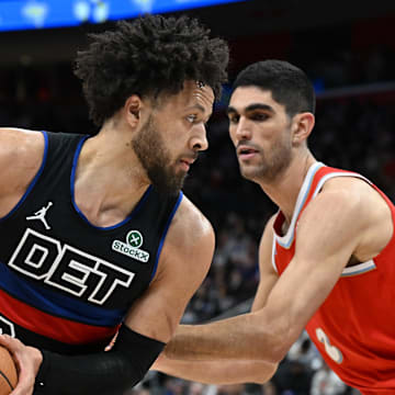 Apr 5, 2025; Detroit, Michigan, USA;  Detroit Pistons guard Cade Cunningham (2) looks to drive past Memphis Grizzlies forward Santi Aldama (7) in the first quarter at Little Caesars Arena. Mandatory Credit: Lon Horwedel-Imagn Images