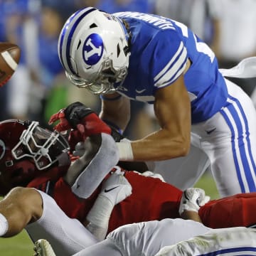 Sep 11, 2021; Provo, Utah, USA; Utah Utes running back Tavion Thomas (9) is stopped by Brigham Young Cougars linebacker Keenan Pili (41) defensive back Ammon Hannemann (22) in the third quarter at LaVell Edwards Stadium.