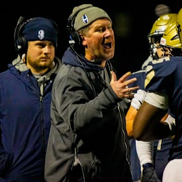 Archbishop Hoban football coach Tim Tyrrell talks to his team during last week's rivalry game against St. Edward.