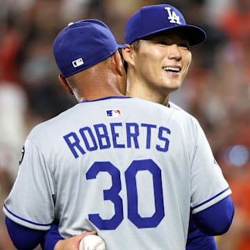 Sep 6, 2025; Baltimore, Maryland, USA; Los Angeles Dodgers pitcher Yoshinobu Yamamoto (18) celebrates with Los Angeles Dodgers manager Dave Roberts (30) during the ninth inning against the Baltimore Orioles at Oriole Park at Camden Yards. Mandatory Credit: Daniel Kucin Jr.-Imagn Images