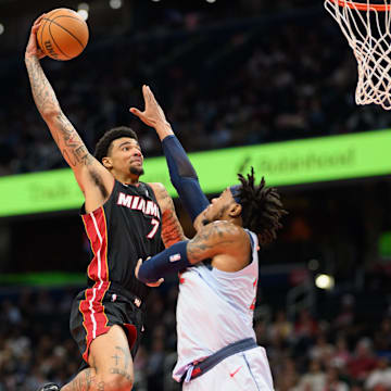 Mar 31, 2025; Washington, District of Columbia, USA; Miami Heat center Kel'el Ware (7) drives to the basket against Washington Wizards forward Richaun Holmes (22) during the second quarter at Capital One Arena. Mandatory Credit: Reggie Hildred-Imagn Images