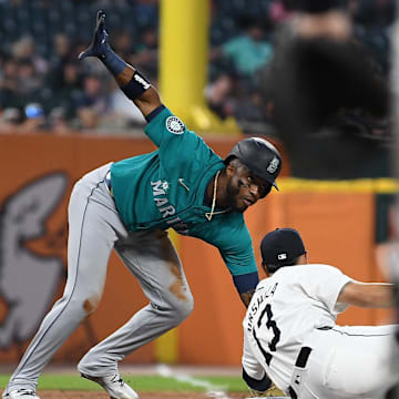 Seattle Mariners center fielder Victor Robles (10) slides safely into third base around the tag of Detroit Tigers third baseman Gio Urshela (13) in the eighth inning at Comerica Park on Aug 14.