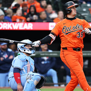 Apr 12, 2025; Baltimore, Maryland, USA; Baltimore Orioles catcher Adley Rutschman (35) hits a home run during the sixth inning against the Toronto Blue Jays at Oriole Park at Camden Yards.