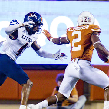 Sep 17, 2022; Austin, Texas, USA; Texas Longhorns running back Roschon Johnson (2) carries the ball in for the touchdown as UTSA Roadrunners safety Clifford Chattman (4) defends during the second quarter at Darrell K Royal-Texas Memorial Stadium. Mandatory Credit: John Gutierrez-Imagn Images