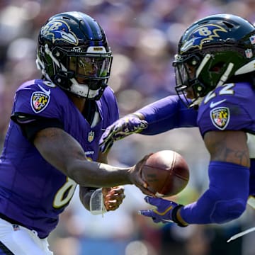 Sep 15, 2024; Baltimore, Maryland, USA; Baltimore Ravens quarterback Lamar Jackson (8) hands off to running back Derrick Henry (22) during the first half against the Las Vegas Raiders at M&T Bank Stadium. Mandatory Credit: Reggie Hildred-Imagn Images