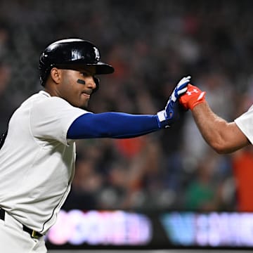 Sep 10, 2024; Detroit, Michigan, USA; Detroit Tigers designated hitter Kerry Carpenter (30) celebrates with Detroit Tigers first baseman Andy Ibanez (77) after scoring a run against the Colorado Rockies in the sixth inning at Comerica Park.