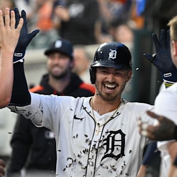 Jul 7, 2025; Detroit, Michigan, USA; Detroit Tigers right fielder Zach McKinstry (39) gets showered with sunflower seeds as he celebrates in the dugout after hitting a home run against the Tampa Bay Rays in the seventh inning at Comerica Park. 