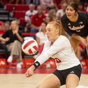 Nebraska defensive specialist Oliva Mauch (front) digs a ball against The Citadel while libero Lexi Rodriguez (back) eyes the ball.