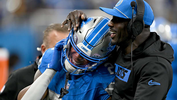 Detroit Lions running back Jahmyr Gibbs celebrates with running backs coach Scottie Montgomery.