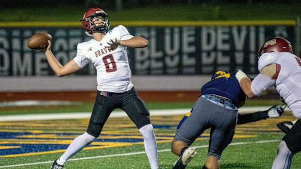 Lake Gibson quarterback Collin Henderson unleashes a 48-yard pass to Derrick McBridge on Friday night at Denison Stadium.