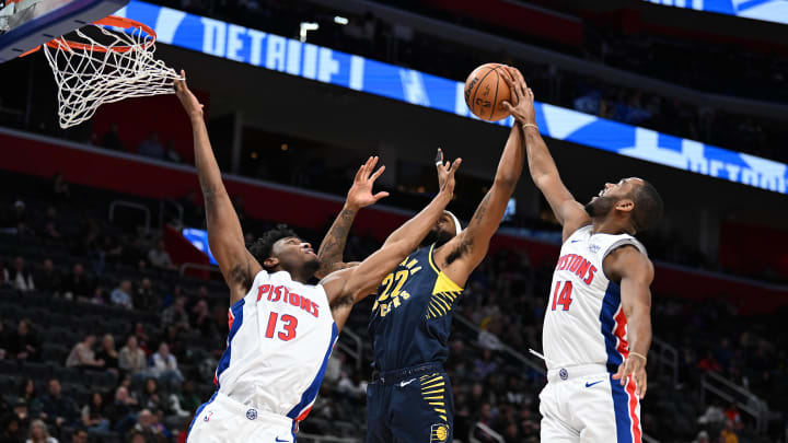 Dec 11, 2023; Detroit, Michigan, USA;  Indiana Pacers forward Isaiah Jackson (22) (center) gets fouled by Detroit Pistons guard Alec Burks (14) (right) while driving to the basket against Burks and center James Wiseman (13) in the first quarter at Little Caesars Arena. Mandatory Credit: Lon Horwedel-USA TODAY Sports