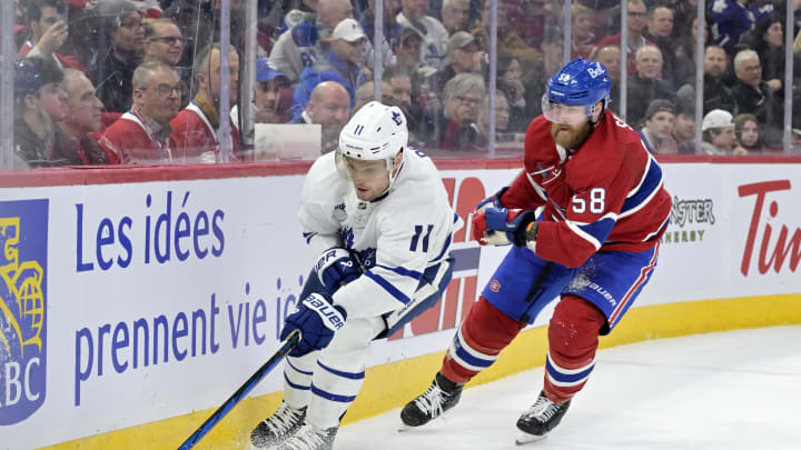 Apr 6, 2024; Montreal, Quebec, CAN; Toronto Maple Leafs forward Max Domi (11) plays the puck and Montreal Canadiens defenseman David Savard (58) defends during the third period at the Bell Centre. Mandatory Credit: Eric Bolte-USA TODAY Sports