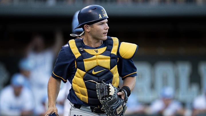 Jun 7, 2024; Chapel Hill, NC, USA; West Virginia Mountaineers Logan Sauve (33) looks toward the field in the fourth inning against the North Carolina Tar Heels during the DI Baseball Super Regional at Boshamer Stadium.  Mandatory Credit: Jeffrey Camarati-Imagn Images
